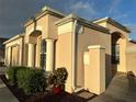 Tan house with arched entryway and white columns at 286 Royal Palm Way, Spring Hill, FL 34608