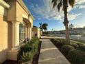 Side view of house showcasing landscaping and walkway at 286 Royal Palm Way, Spring Hill, FL 34608