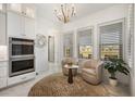 Kitchen breakfast nook with two armchairs and a decorative rug at 33843 Galley Way, Wesley Chapel, FL 33543