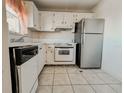 Small kitchen with white cabinets and appliances at 4210 Ironwood Cir # 403J, Bradenton, FL 34209