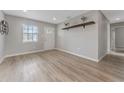 Bright living room with light wood floors and a floating shelf at 4724 W Lawn Ave, Tampa, FL 33611