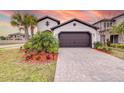 A lovely house with a brown garage door and brick driveway at 4761 San Martino Dr, Wesley Chapel, FL 33543