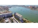 Aerial view of condo, waterfront, boats, and surrounding buildings at 644 Island Way # 206, Clearwater, FL 33767