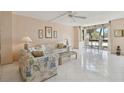 Bright living room with tile floors, large windows, and comfy seating at 644 Island Way # 206, Clearwater, FL 33767