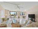 Spacious living room with tile floors, water view, and comfy seating at 644 Island Way # 206, Clearwater, FL 33767