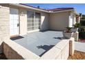 Front entrance with a gray porch and potted plants at 6911 El Camino Paloma St, Port Richey, FL 34668