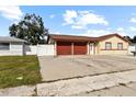 House exterior showcasing a two-car garage and front yard at 7007 Lambright Ct, Tampa, FL 33634