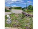 Landscaped yard with a lion statue and palm tree at 8490 Leopold Ave, North Port, FL 34287