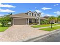 Two-story home with a paver driveway and landscaped yard at 9426 59 N St, Pinellas Park, FL 33782