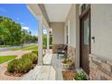 Inviting front porch with a stone accent wall and seating area at 9426 59 N St, Pinellas Park, FL 33782