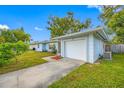 Light blue house with a white garage door and grassy yard at 10 N Mercury Ave, Clearwater, FL 33765