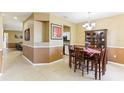 Elegant dining room featuring a chandelier, hutch, and decorative accents at 10757 Carloway Hills Dr, Wimauma, FL 33598