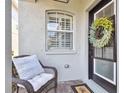 Inviting front porch featuring a charming chair, decorative wreath, and stylish entrance at 11132 Roseate Dr, Tampa, FL 33626