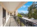 Private balcony overlooks parking and lush landscape at 11485 Oakhurst Rd # A301, Largo, FL 33774