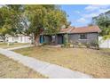 Gray house with teal door and well-maintained lawn at 1232 Calamondin Dr, Holiday, FL 34691