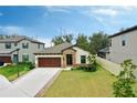 One-story house with a brown door and nicely landscaped front yard at 14610 Horse Trot Rd, Lithia, FL 33547