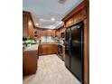 Spacious kitchen with granite countertops and dark wood cabinets at 14655 Pine Glen Cir, Lutz, FL 33559