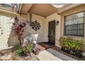 Front entry with bench, potted plants, and a tiled floor at 170 Eric Ct, Oldsmar, FL 34677