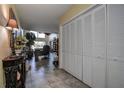 View down a hallway with coat closet and glimpse of living area at 170 Eric Ct, Oldsmar, FL 34677