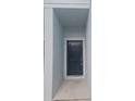 Modern dark gray front door with simple white trim at 19639 Shady Oak Dr, Land O Lakes, FL 34638