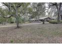 Long driveway leading to a ranch house in the woods at 20490 Pinewood Dairy Rd, Brooksville, FL 34601