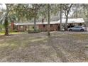 Ranch style brick home with metal roof and large lot at 20490 Pinewood Dairy Rd, Brooksville, FL 34601