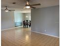 Bright, open living area with tile floors, ceiling fans, and dining area beyond at 2134 Victory Ave, Largo, FL 33770