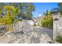 Long driveway leading up to this home with a privacy wall at 2186 Coffee Pot Ne Blvd, St Petersburg, FL 33704