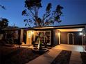 Dark-colored house exterior with a driveway and landscaping visible at night at 2311 Wellesley, Bradenton, FL 34207