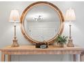 Entryway features a round mirror, console table, and lamps at 2717 Briarpatch Dr, Valrico, FL 33596