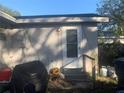 Backyard with a door, grill, and propane tanks at 3019 E Louisiana Ave, Tampa, FL 33610