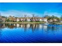 Scenic view of the community lake with a fountain in front of the condo building at 3377 Crystal E Ct # E, Palm Harbor, FL 34685