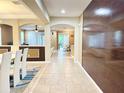 Bright and spacious entryway with tile floors and wood accent wall at 4110 Huntingdale Ct, Wesley Chapel, FL 33543