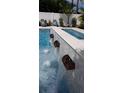 Close-up of the pool's water features, showing copper spillways and tranquil waterfalls at 430 173Rd E Ave, North Redington Beach, FL 33708