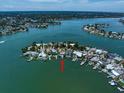 Wide aerial showcasing the home's waterfront location and neighborhood at 476 Harbor S Dr, Indian Rocks Beach, FL 33785