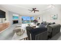 Spacious living room with fireplace, water views, and ample seating at 476 Harbor S Dr, Indian Rocks Beach, FL 33785