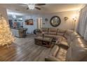 Spacious living room with a sectional sofa, coffee table, and Christmas tree at 5108 Redwood Ter, North Port, FL 34286