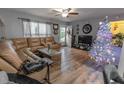 Living room featuring hardwood floors, sectional sofa, and a TV at 5108 Redwood Ter, North Port, FL 34286