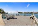 Waterfront property features a spacious wooden dock, complete with seating and stunning water views at 521 Harbor N Dr, Indian Rocks Beach, FL 33785