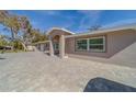 Modern home with a paved driveway and large windows at 659 Keene Rd, Largo, FL 33771