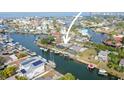 Aerial view of waterfront homes with private docks and boats along a tranquil canal and beautiful blue water at 6702 Harbor Dr, Hudson, FL 34667