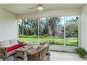 Inviting screened patio with comfortable seating overlooking the lush backyard, perfect for relaxing at 7408 Trovita Rd, Land O Lakes, FL 34637