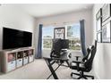 Home office with desk, TV, and comfortable chair at 10023 Eventide Trl, Parrish, FL 34219