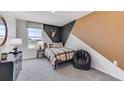 Bedroom with a bed, beanbag chair, and unique wall design at 10574 Dusty Boot Rd, Land O Lakes, FL 34638