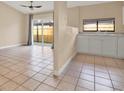 Open kitchen with white cabinets, stainless steel appliances, and tile floors at 11408 Midfield Way # 11408, Tampa, FL 33624