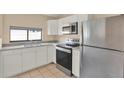 Galley-style kitchen featuring stainless steel appliances and granite countertops at 11408 Midfield Way # 11408, Tampa, FL 33624
