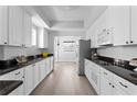 Modern kitchen with sleek white cabinets, granite countertops, and stainless steel appliances at 12033 Gandy N Blvd # 145, St Petersburg, FL 33702