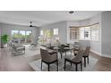 Bright living and dining area with modern furnishings, a ceiling fan, and sliding glass doors to the balcony at 12033 Gandy N Blvd # 145, St Petersburg, FL 33702