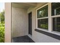 Condo entrance with a black door and a large window at 1303 S Hercules Ave # 1, Clearwater, FL 33764