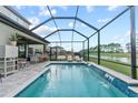 Inviting swimming pool with a covered patio and water feature at 14866 Paddock Pond Ave, Lithia, FL 33547